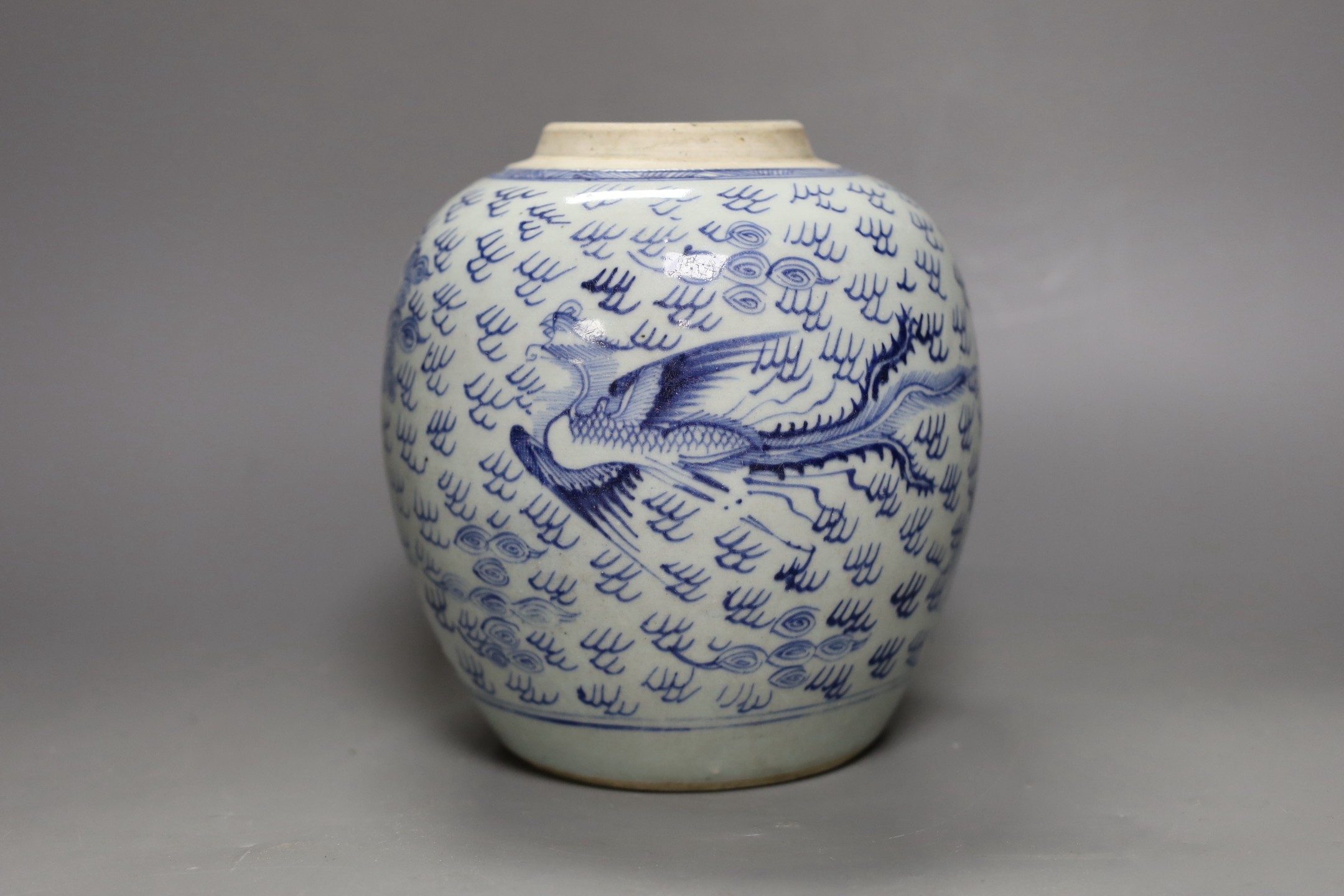 An 18th century Chinese provincial blue and white ‘dragon and phoenix’ jar, 19cm